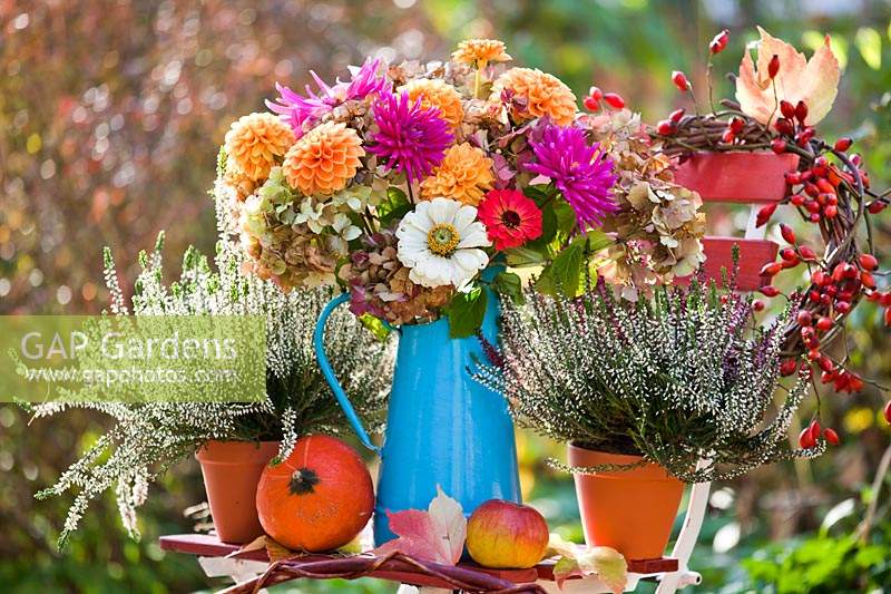 Bouquet of autumn flowers in jug. Dahlias, Zinnia, Hydrangea, Heather.