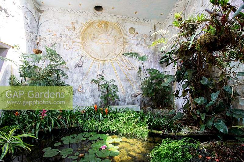 Pond with planting and decoration inspired by mythology dedicated to Apollo. Giardini La Mortella, Isle of Ischia, Italy. Temple of the Sun, Tempio del Sole. 
