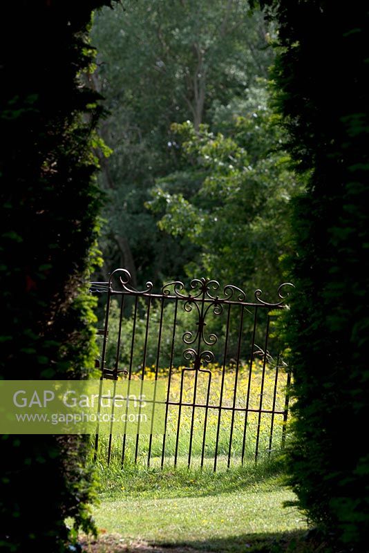 View through iron gate at Bryan's Ground garden, Presteigne, Herefordshire. 