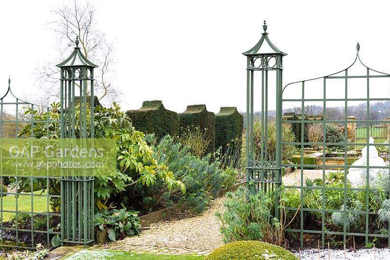 Green painted trellis garden divider with entrance