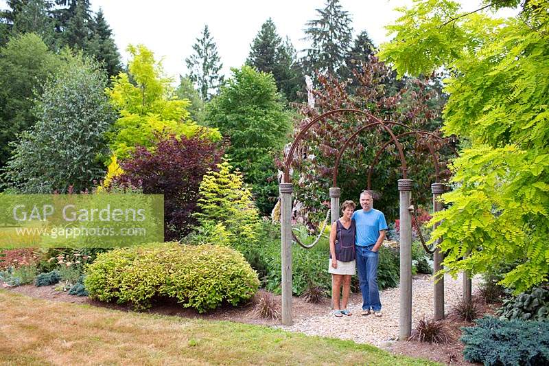 Couple standing together in their rural garden