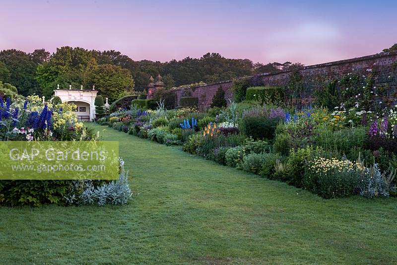 The 90-metre-long twin herbaceous borders at dawn, Arley Hall, Cheshire, UK. 

