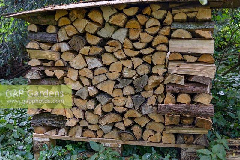 Carefully stacked wooden logs for fire.   