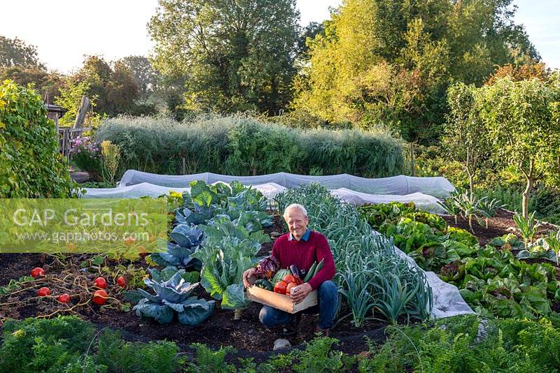 Charles Dowding with a box of vegetables from his garden at Homeacres in Somerset