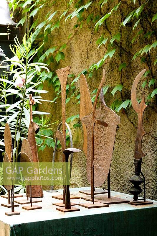 Metal sculpture artworks displayed in Italian garden. 