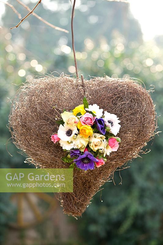 Heart shaped display of camomile, roses, ranunculus, anemone,