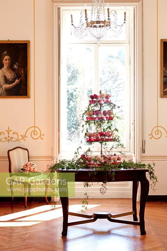 Wedding decoration of roses displayed in a tier on a table inside villa