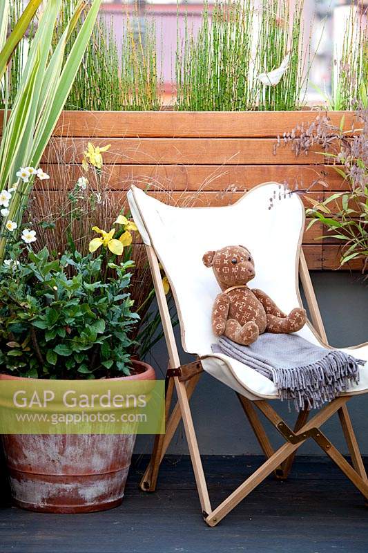 Chair with teddy bear on terrace