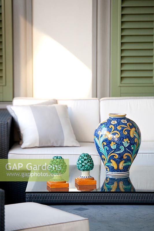 Ceramics on rattan furniture - terrace next to house in summer 