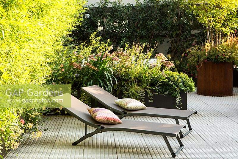 Two recliners stand in terrace garden, Italy. 