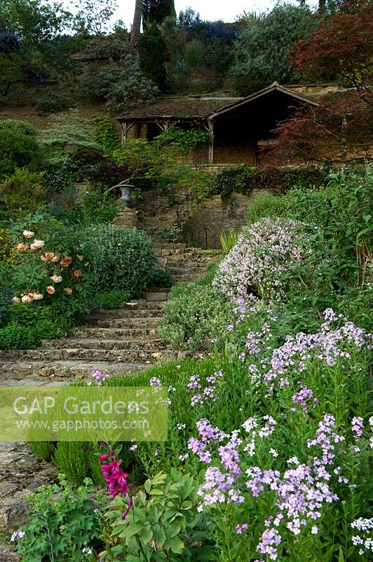 Stone steps through terraced garden to summerhouse on middle terrace. 