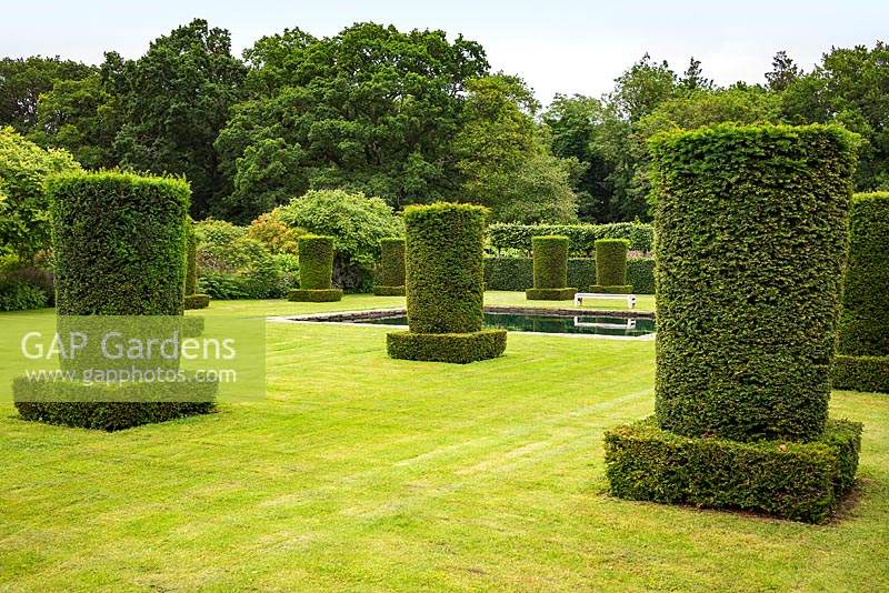 Clipped Yew columns - Taxus baccata in the Silent Garden at Scampston Hall Walled Garden, North Yorkshire, UK. 