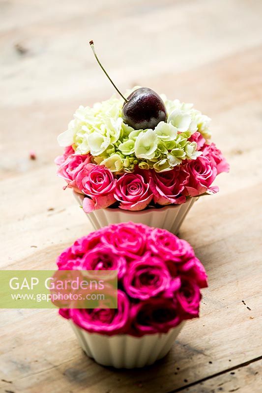 Floral cupcake arrangement with rose buds, Rosa 'Lovely Lydia' and 'Nathalie Nypels', Hydrangea 'Groen' and a cherry