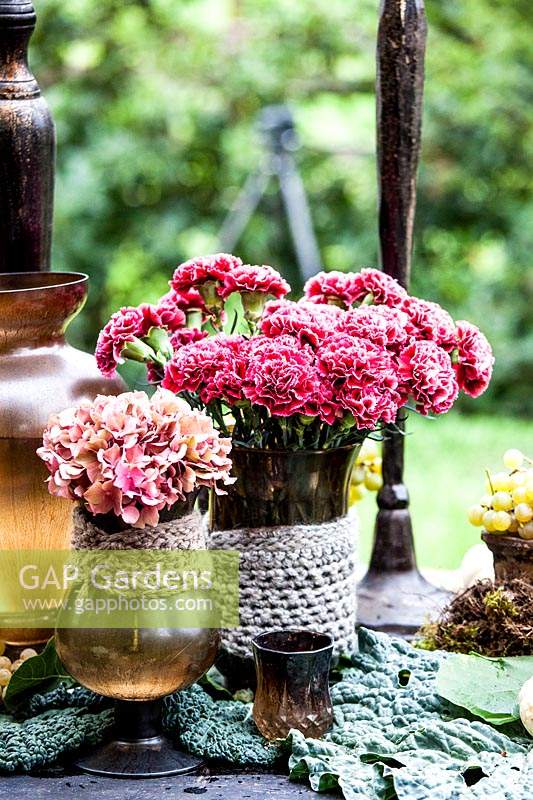 Vases with hydrangea and dianthus.