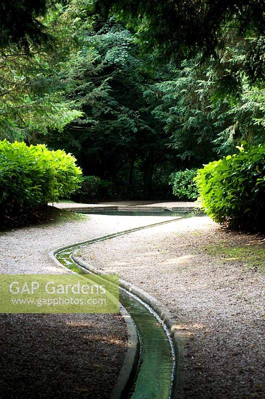 Meandering water rill travelling through country garden