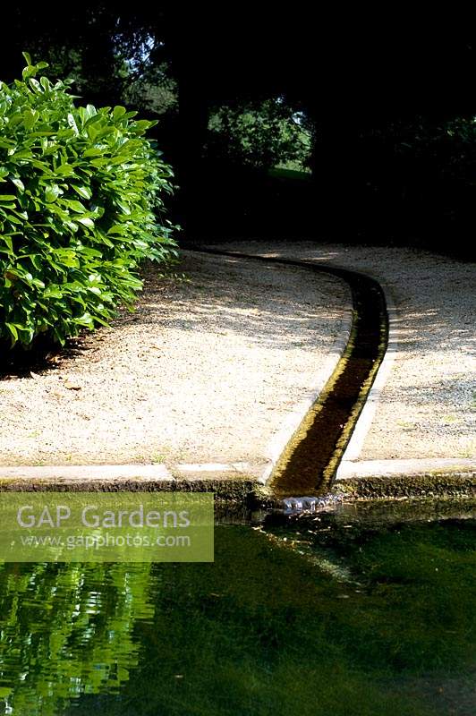 Meandering water rill travelling through to pond