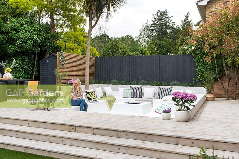 Sunken seating surrounded with wooden decking.