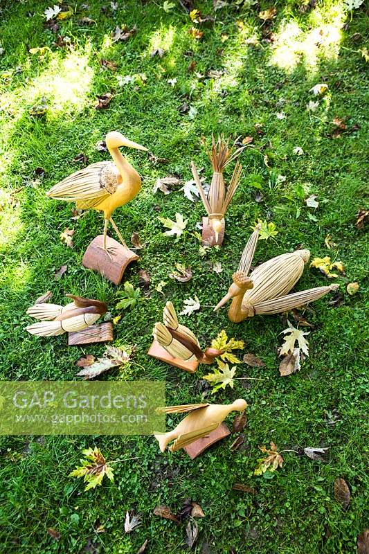 Collection of different birds and ducks carved from wood and grasses