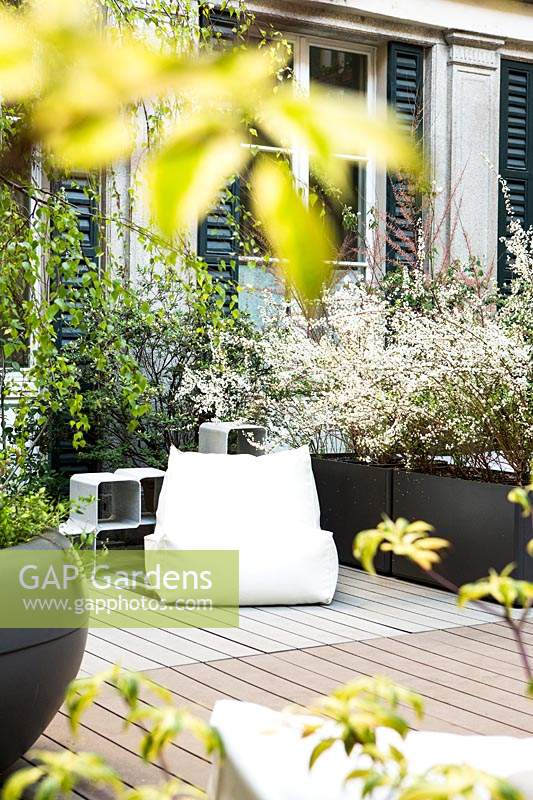 Large white beanbag chair in modern garden. 
