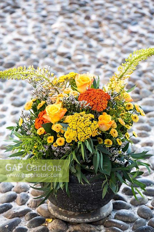 Bouquet of flowers with roses, Achillea, Solidago and chrysanthemums. 