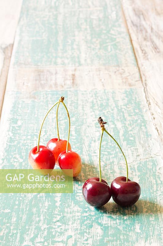 Cherries on wooden surface. 