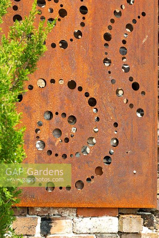 Detail of a decorative rusty wall mounted panel.