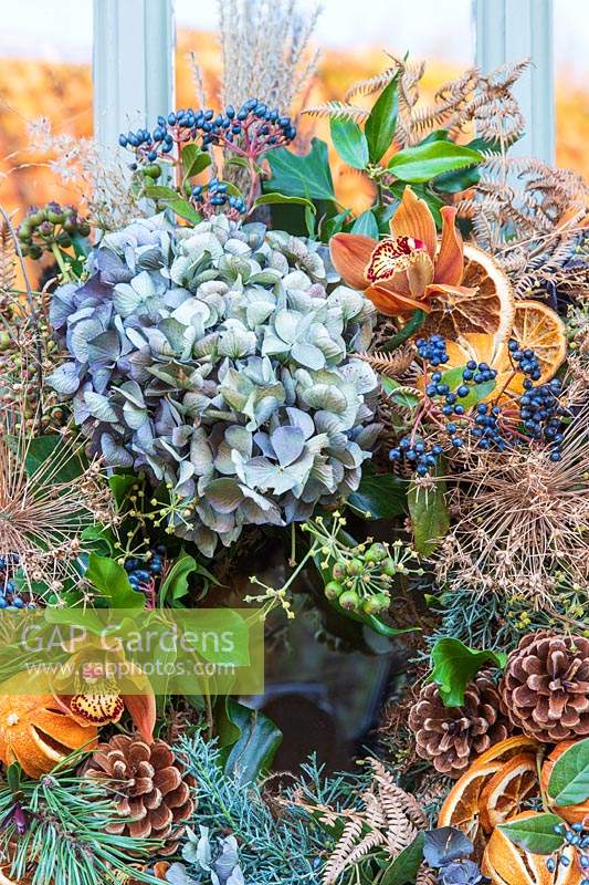 Close up detail of rustic orange, green and blue festive wreath