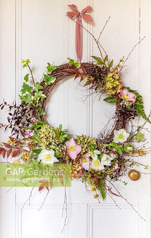 Bright and colourful New Year Half Wreath hung on white wooden door