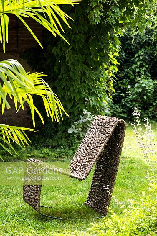 Handcrafted woven Salix - Willow - rocking chair on lawn 