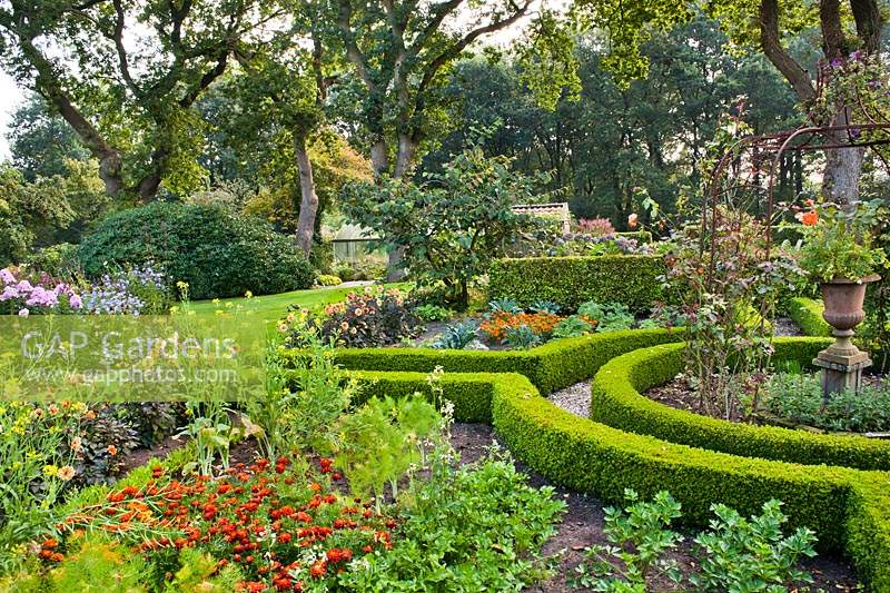Low hedging parterre dividing vegetable and flower beds and pathways.
