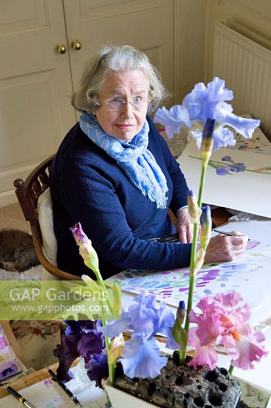 Ann Fraser in her studio painting irises. 