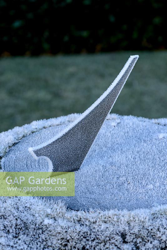 Frost-covered garden sundial. 