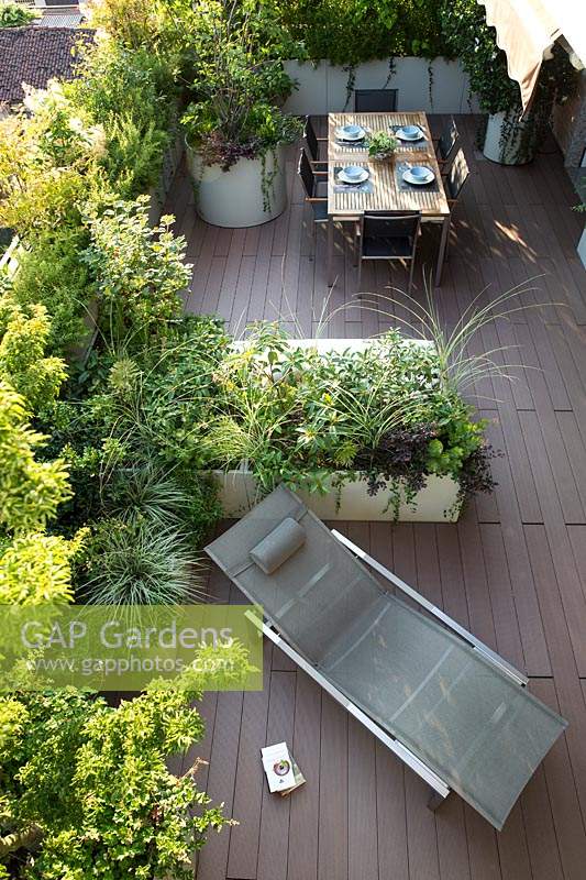 Looking down on roof terrace, showing decking, and the layout of the planters to divide the dining and relaxing areas 