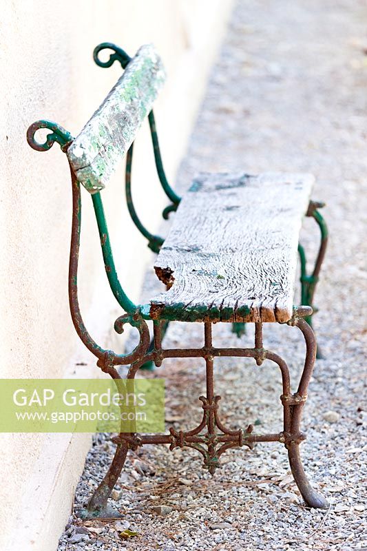 Vintage garden bench on gravel 