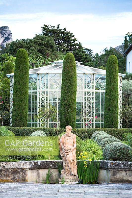 Mixed topiary on the terrace, with formal sculpture. The garden focuses on perfumed evergreens - pitosfori, olive trees, oleanders and lonicera nitida.