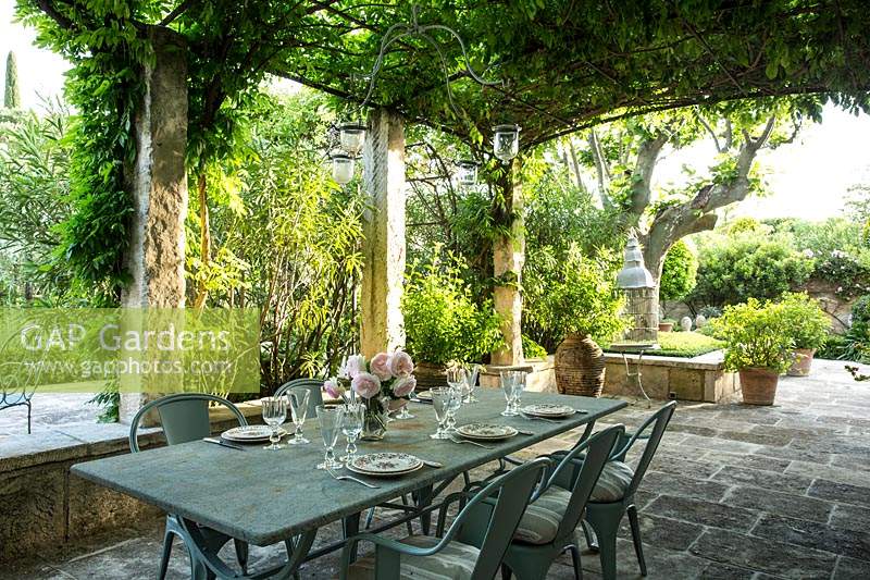 The dining table set under the wisteria pergola