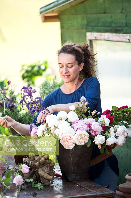Woman making a cut flower arrangement 