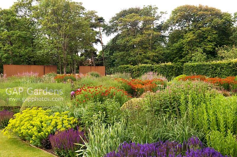View over extensive perennial flower beds in wall garden 