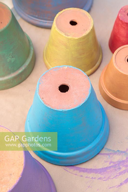 Freshly-painted terracotta pots in rainbow colours
