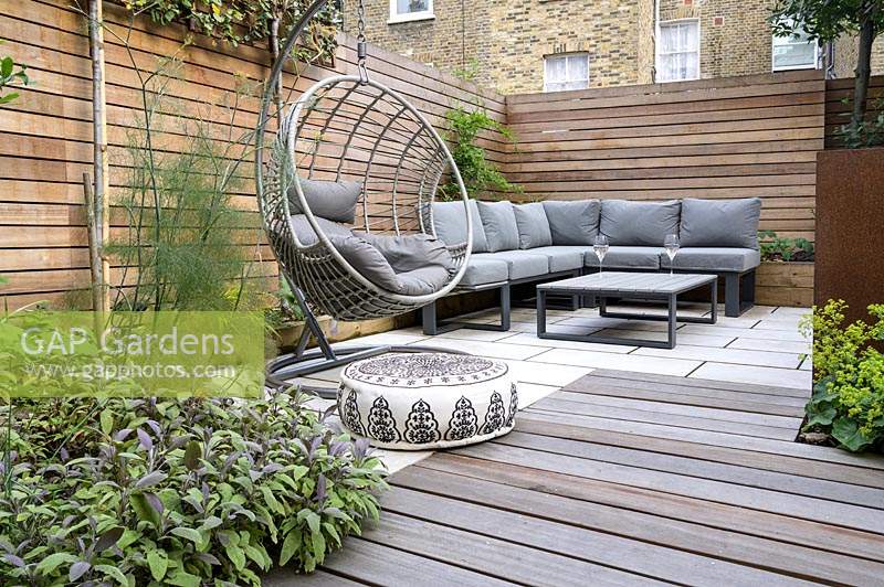 Modern Small Outdoor Room  with decking, seating area, hanging chair and a sofa