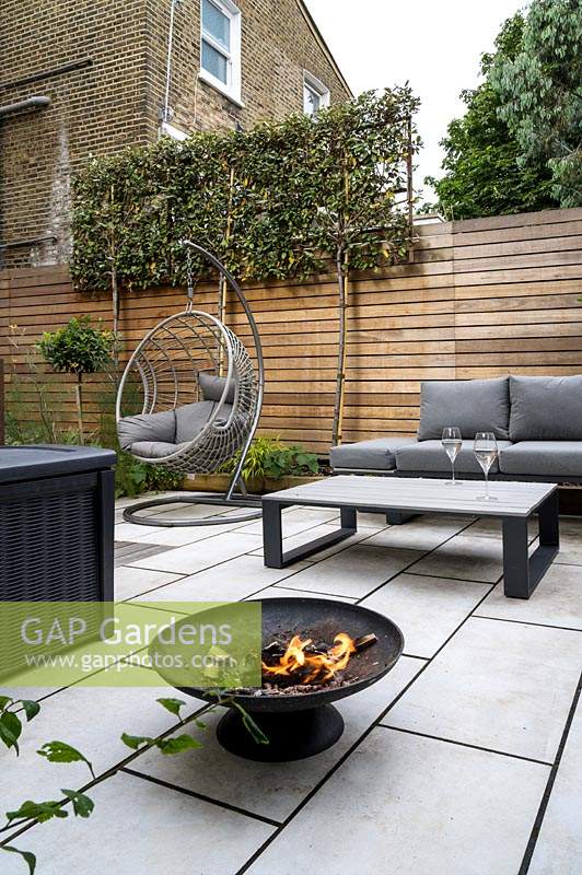 Modern Small Outdoor Room with, seating area, hanging chair and a fire pit