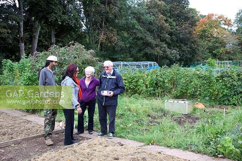 Couple chatting to friends at the allotment