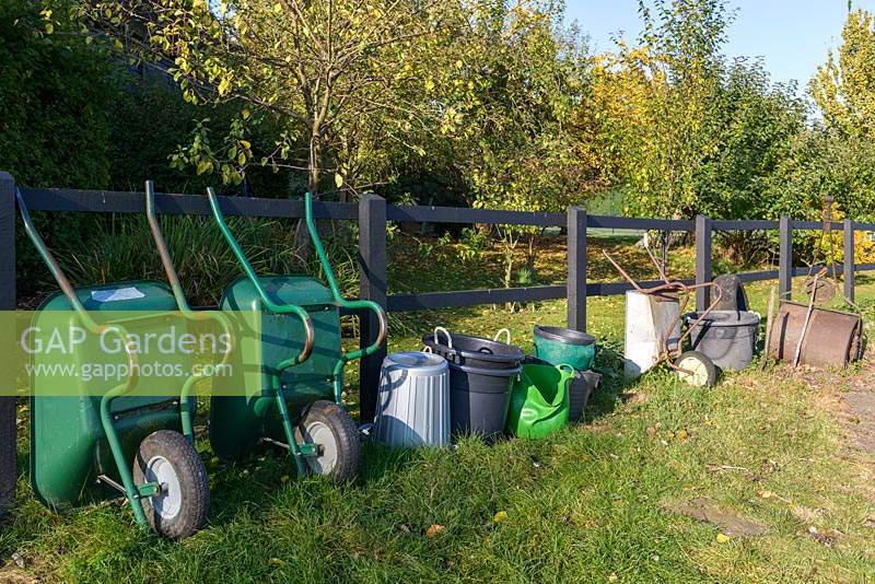 Lined up gardening equipment, including wheelbarrows