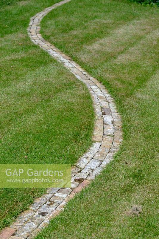 Winding brick path through a lawn