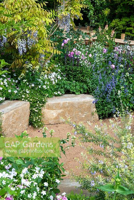 Summer bed of perennials with stone blocks edging gravel path - RHS Chelsea Flower Show