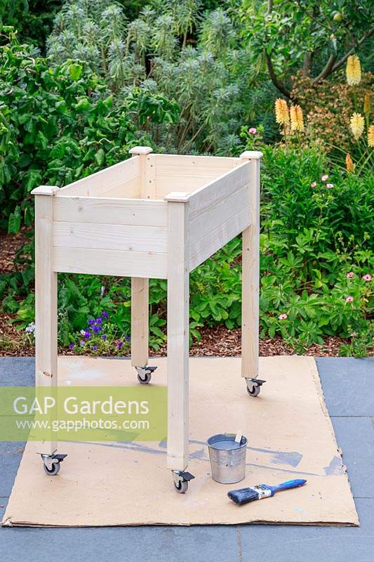Built raised wooden planter with casters, ready to be painted