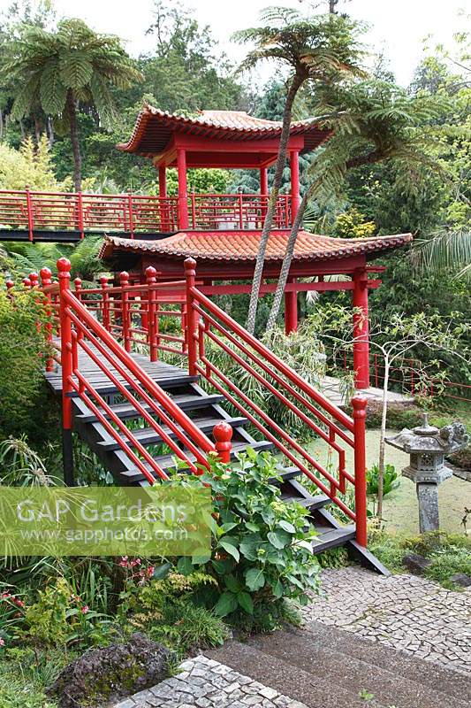 Lower Oriental-inspired garden with steps, handrail and viewing point with woodwork painted red