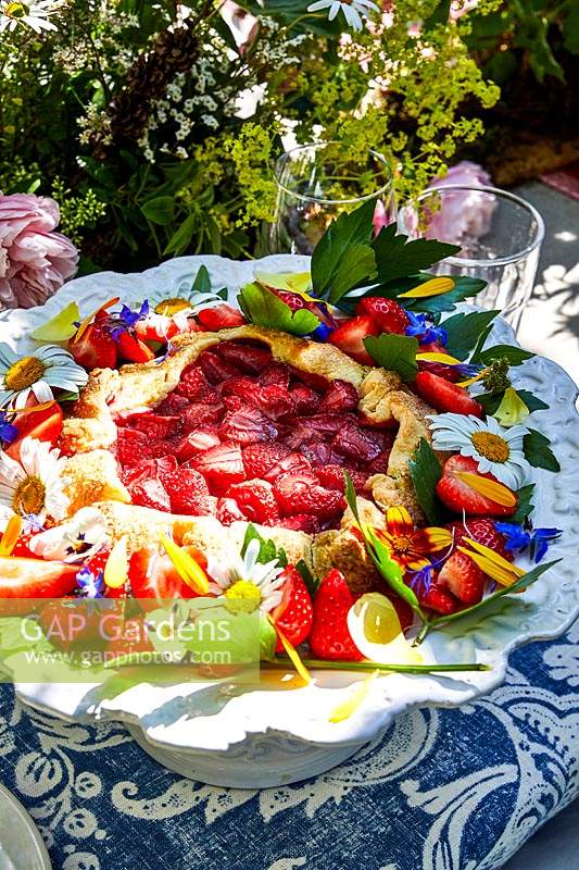Freeform fruit pie decorated with edible flowers