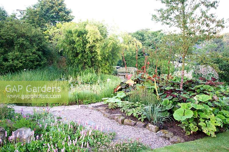View over pond at  Bluebell Cottage Gardens, Cheshire, UK