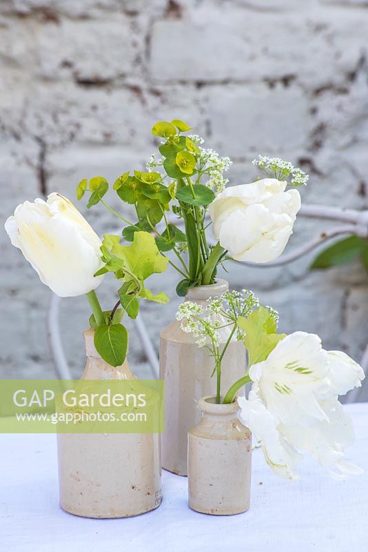 Simple spring floral arrangement of white tulipas and green foliage